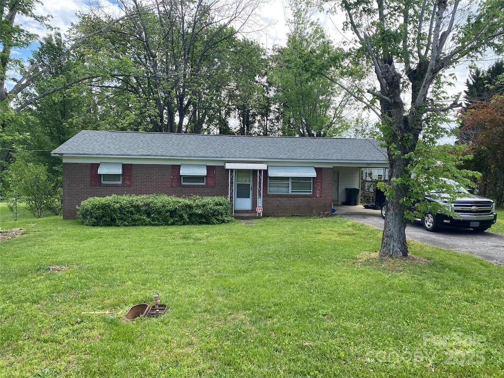 321 Sheldon St, Hudson, NC 28638 - ranch-style home featuring a carport, a front yard, driveway, and brick siding