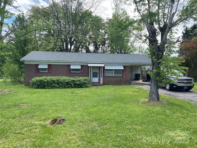 321 Sheldon St, Hudson, NC 28638 - ranch-style home featuring a carport, a front yard, driveway, and brick siding