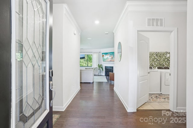 16427 Cozy Cove Rd, Charlotte, NC 28278 - entryway featuring washer / clothes dryer, wood finished floors, a fireplace, baseboards, and ornamental molding