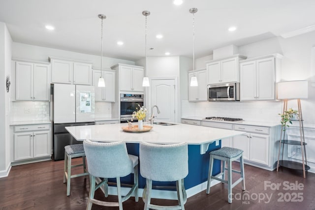 16427 Cozy Cove Rd, Charlotte, NC 28278 - kitchen featuring a sink, stainless steel appliances, tasteful backsplash, dark wood finished floors, and an island with sink