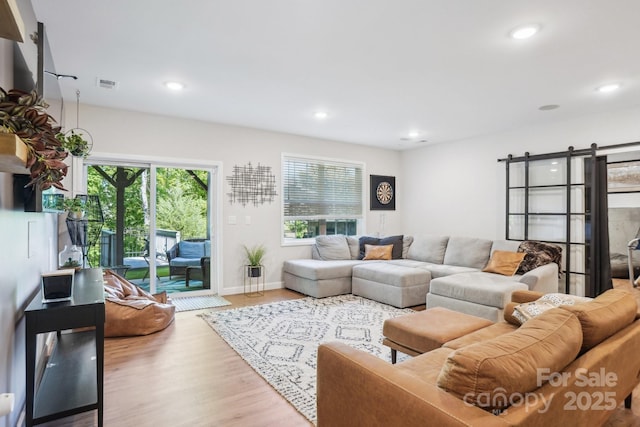 16427 Cozy Cove Rd, Charlotte, NC 28278 - living area featuring recessed lighting, wood finished floors, baseboards, and a barn door
