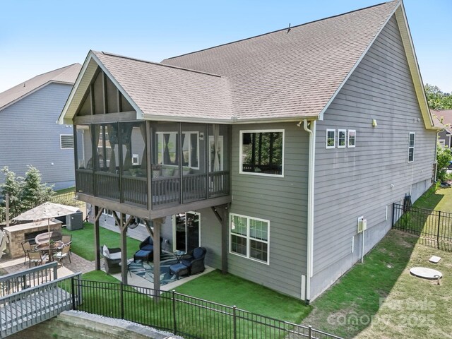 16427 Cozy Cove Rd, Charlotte, NC 28278 - rear view of house featuring a sunroom, a patio, roof with shingles, and central air condition unit