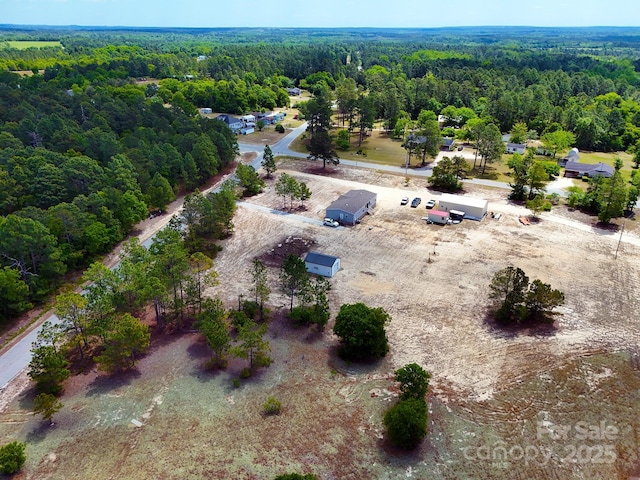 drone / aerial view featuring a view of trees