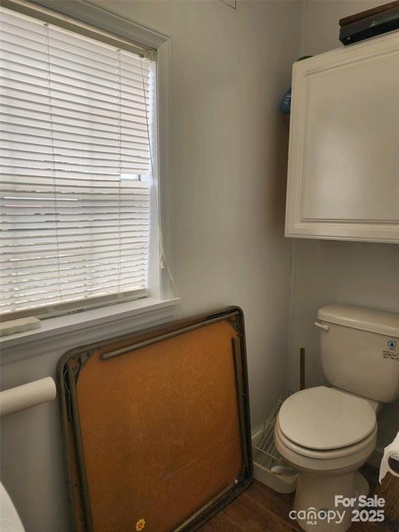 bathroom with toilet and wood finished floors