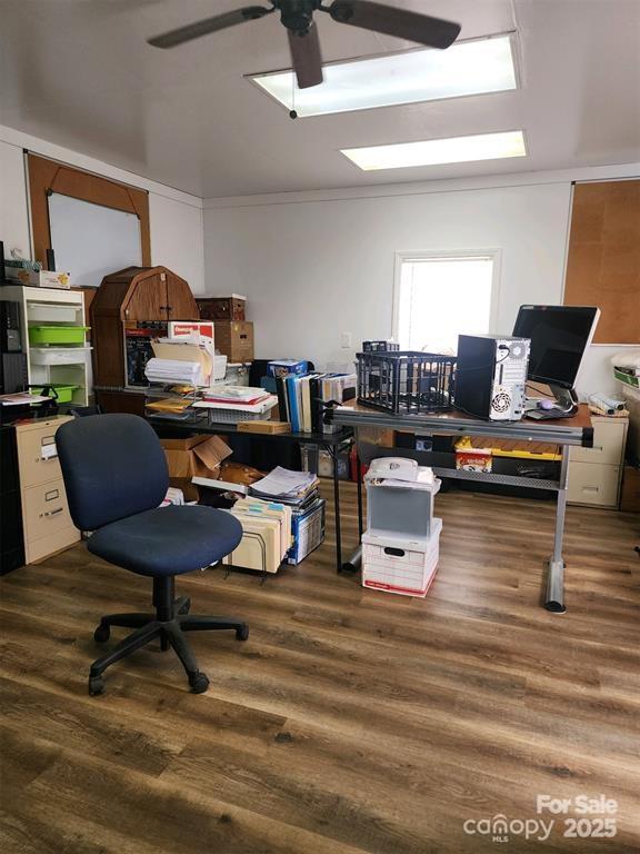 home office with a ceiling fan and wood finished floors