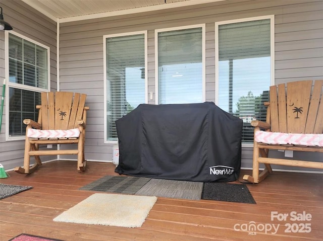 wooden terrace featuring a grill and a porch