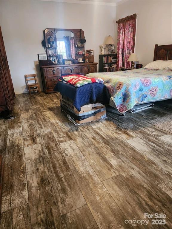 bedroom featuring ornamental molding and hardwood / wood-style floors