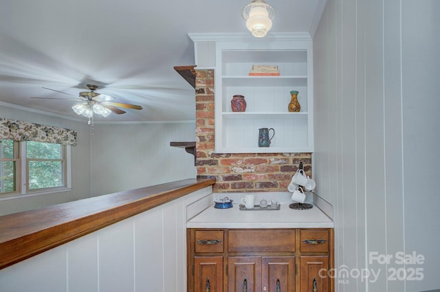 bar with crown molding, a ceiling fan, and a decorative wall