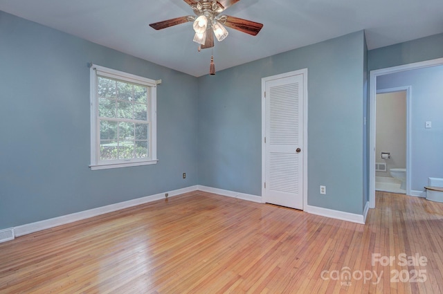 unfurnished bedroom featuring baseboards, visible vents, light wood finished floors, and a closet