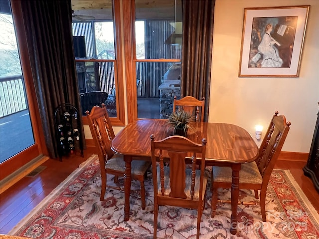 dining area with wood finished floors and baseboards