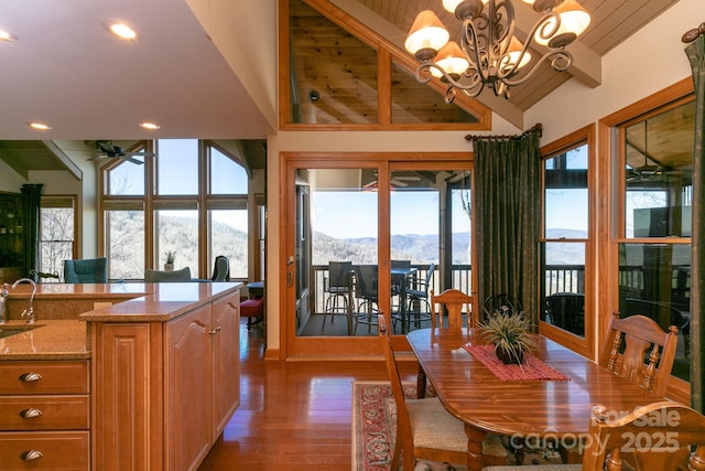 dining space with a mountain view, wood finished floors, healthy amount of natural light, a chandelier, and recessed lighting