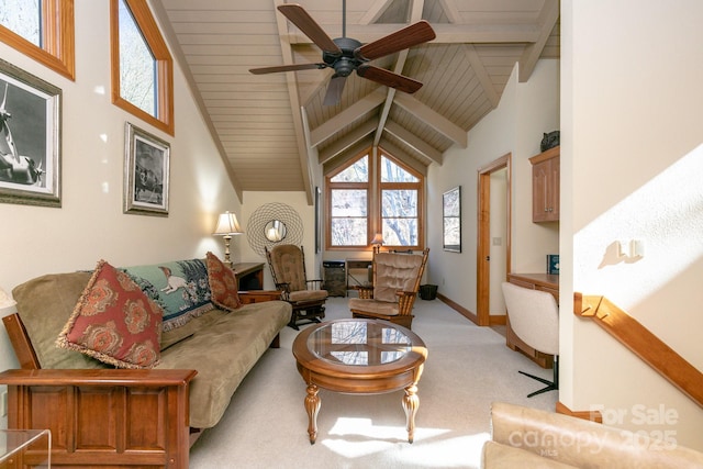 living room with beam ceiling, carpet floors, wooden ceiling, a ceiling fan, and baseboards