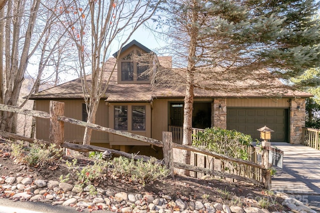 view of front of house with a shingled roof, driveway, and a garage