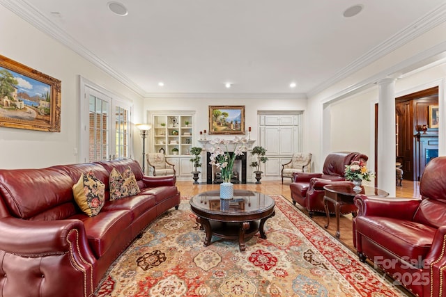 3314 Leamington Ln, Charlotte, NC 28226 - living room featuring a fireplace with flush hearth, decorative columns, wood finished floors, ornamental molding, and recessed lighting