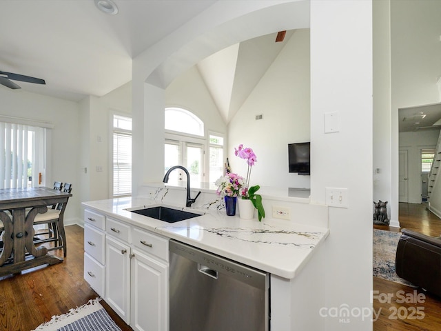 kitchen with plenty of natural light, stainless steel dishwasher, ceiling fan, a sink, and white cabinetry