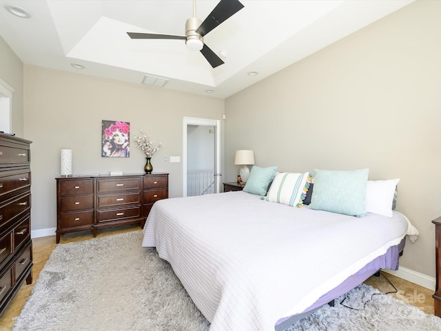 bedroom with a ceiling fan, a skylight, visible vents, baseboards, and recessed lighting