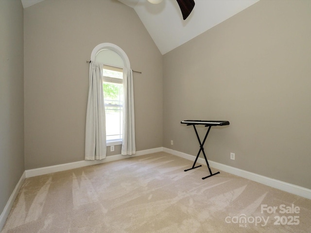spare room with light colored carpet, baseboards, lofted ceiling, and ceiling fan
