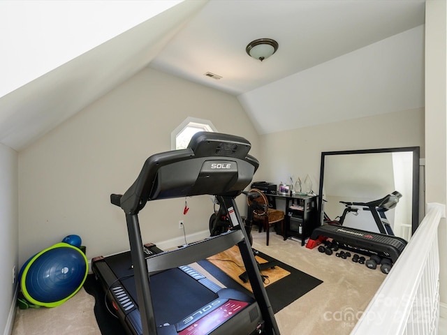 exercise area featuring lofted ceiling, carpet flooring, and visible vents