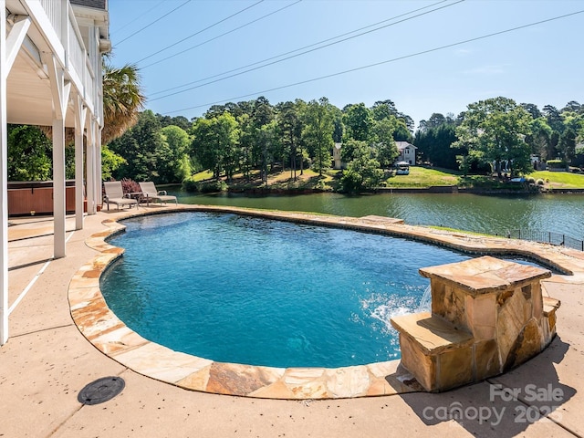 pool featuring a patio area and a water view