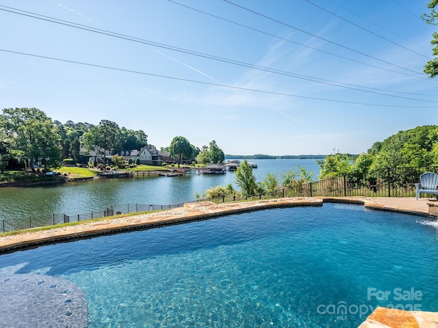 view of pool featuring a water view, fence, and a fenced in pool