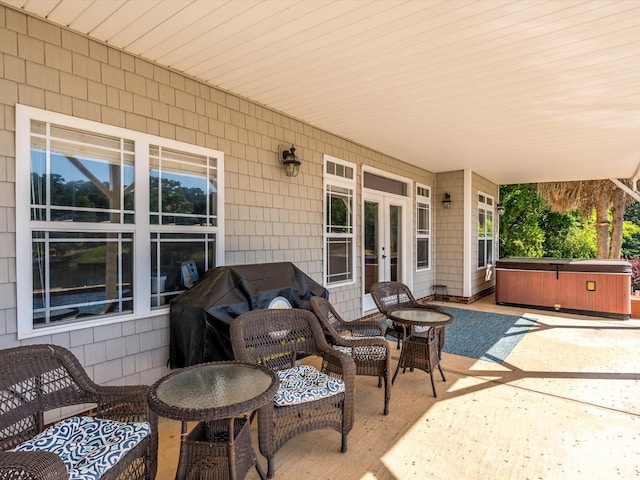 view of patio / terrace with a hot tub and french doors