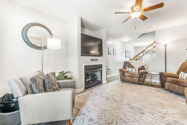 41 Lanceford Cir, Fletcher, NC 28732 - living room featuring stairway, a ceiling fan, baseboards, and a fireplace