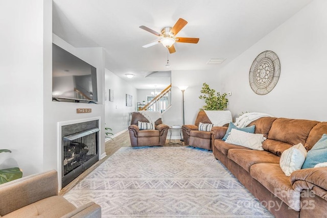 41 Lanceford Cir, Fletcher, NC 28732 - living room with stairway, a fireplace, ceiling fan, baseboards, and carpet