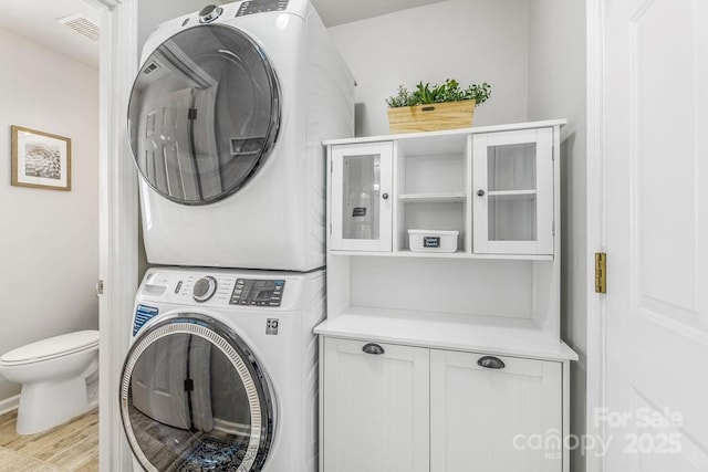41 Lanceford Cir, Fletcher, NC 28732 - laundry area with stacked washer / drying machine and light wood finished floors