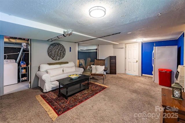 living room featuring carpet flooring, a textured ceiling, and washer / clothes dryer