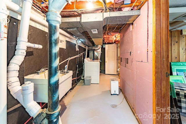 unfinished below grade area with washer / clothes dryer and visible vents