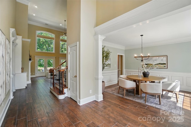 dining room featuring dark wood finished floors, plenty of natural light, and stairway