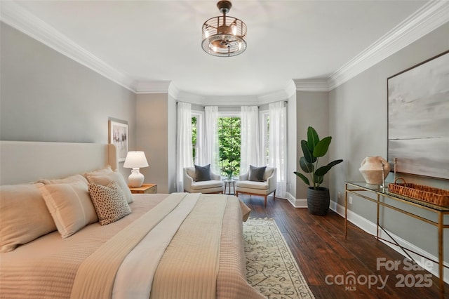 bedroom with crown molding, baseboards, and hardwood / wood-style floors
