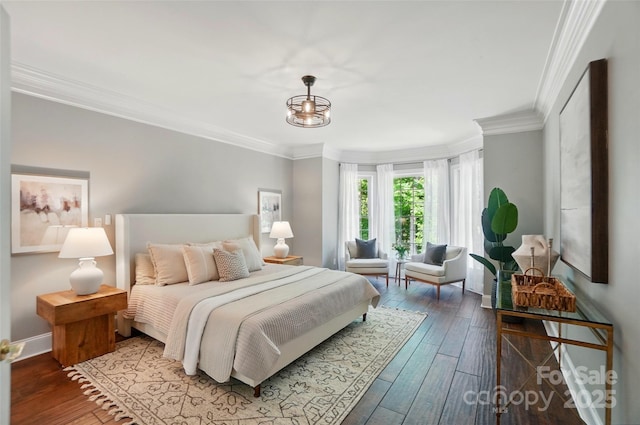 bedroom with baseboards, ornamental molding, and hardwood / wood-style floors