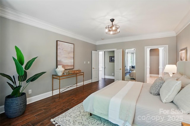 bedroom with crown molding, baseboards, and wood finished floors