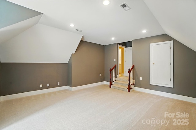 additional living space featuring visible vents, light carpet, recessed lighting, and lofted ceiling