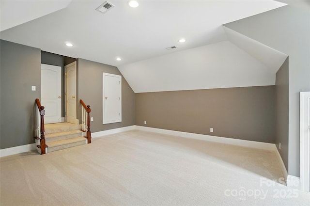 bonus room featuring visible vents, light colored carpet, recessed lighting, and vaulted ceiling
