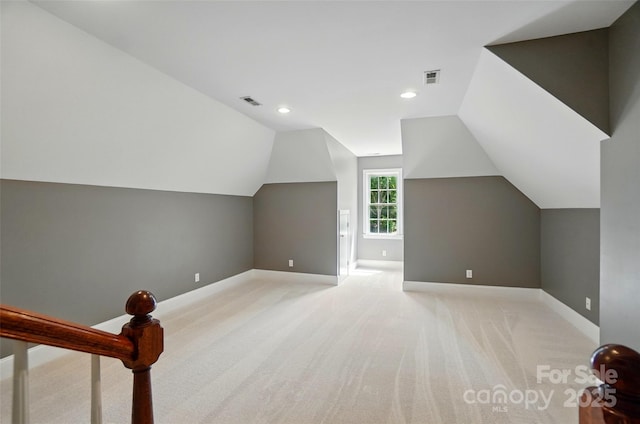 bonus room with light colored carpet, baseboards, visible vents, and lofted ceiling