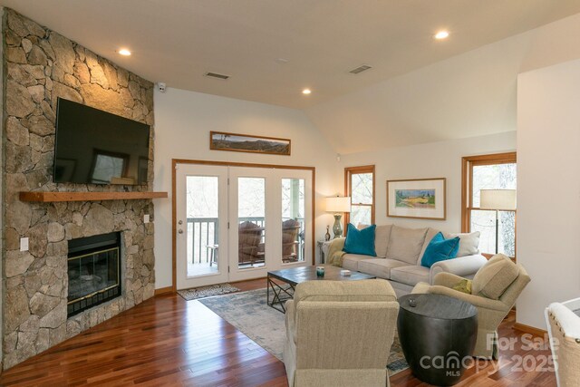 220 Stoney Falls Loop Unit C/2, Burnsville, NC 28714 - living room with visible vents, a stone fireplace, wood finished floors, and vaulted ceiling