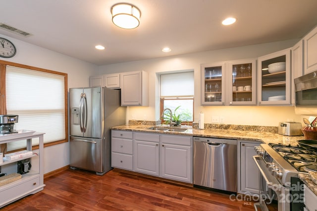 220 Stoney Falls Loop Unit C/2, Burnsville, NC 28714 - kitchen featuring light stone countertops, a sink, stainless steel appliances, visible vents, and glass insert cabinets