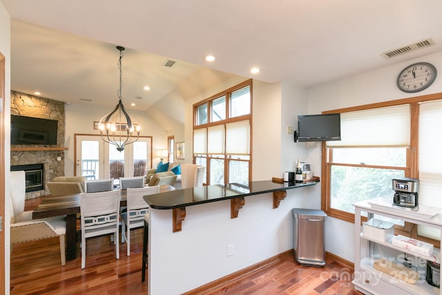220 Stoney Falls Loop Unit C/2, Burnsville, NC 28714 - kitchen featuring plenty of natural light, visible vents, wood finished floors, a notable chandelier, and open floor plan