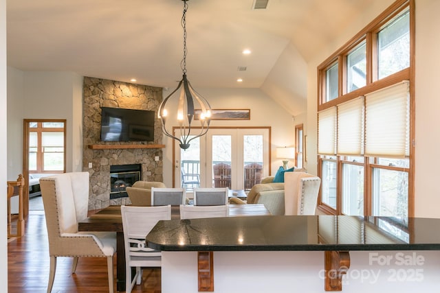 220 Stoney Falls Loop Unit C/2, Burnsville, NC 28714 - dining area featuring a stone fireplace, visible vents, wood finished floors, a notable chandelier, and recessed lighting