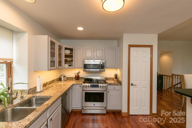 220 Stoney Falls Loop Unit C/2, Burnsville, NC 28714 - kitchen with glass insert cabinets, dark wood-type flooring, light stone counters, a sink, and stainless steel appliances