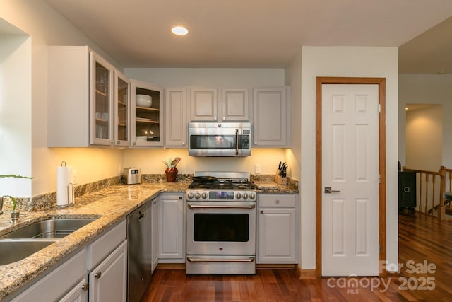 220 Stoney Falls Loop Unit C/2, Burnsville, NC 28714 - kitchen featuring glass insert cabinets, dark wood-style floors, light stone counters, a sink, and stainless steel appliances