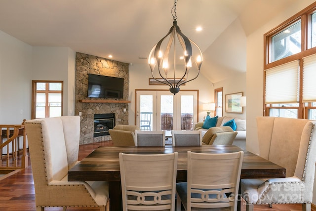 220 Stoney Falls Loop Unit C/2, Burnsville, NC 28714 - dining area featuring a healthy amount of sunlight, a fireplace, wood finished floors, and a chandelier