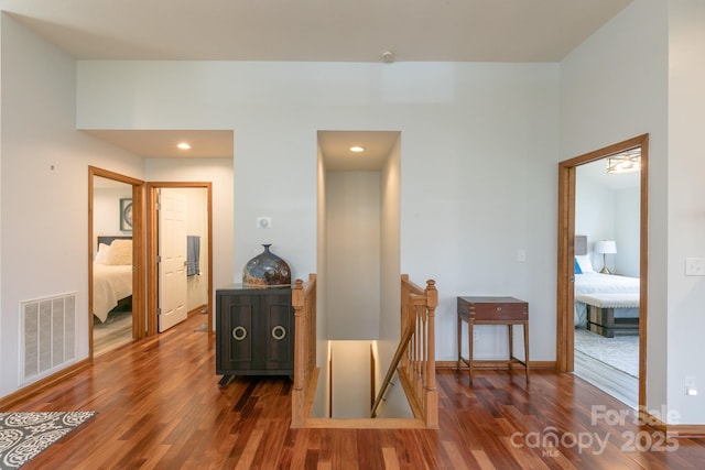 220 Stoney Falls Loop Unit C/2, Burnsville, NC 28714 - hallway featuring visible vents, wood finished floors, baseboards, an upstairs landing, and recessed lighting