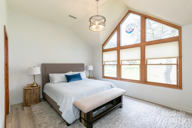 220 Stoney Falls Loop Unit C/2, Burnsville, NC 28714 - bedroom featuring baseboards, vaulted ceiling, wood finished floors, and visible vents