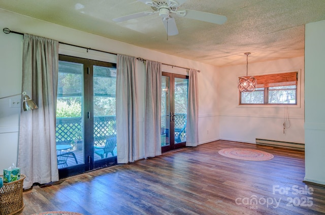 spare room with plenty of natural light, baseboard heating, french doors, and wood finished floors