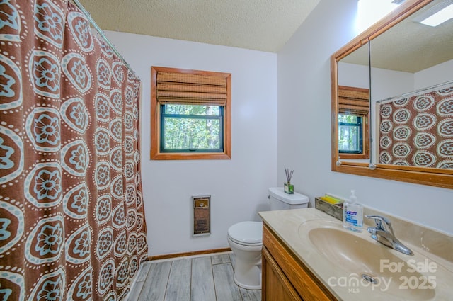 full bath featuring vanity, toilet, a textured ceiling, curtained shower, and wood finished floors