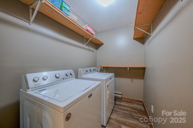 clothes washing area featuring laundry area, a textured ceiling, independent washer and dryer, baseboard heating, and wood finished floors