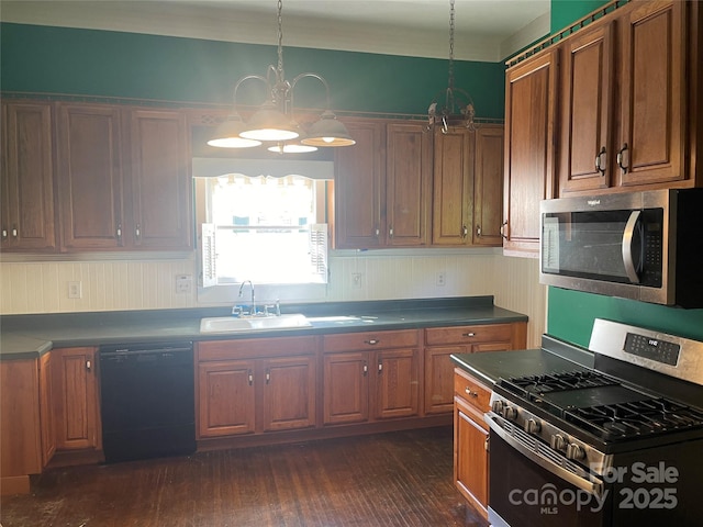 kitchen with appliances with stainless steel finishes, a chandelier, dark wood-style flooring, brown cabinetry, and dark countertops
